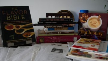 collection of cookbooks and recipes printed from the internet